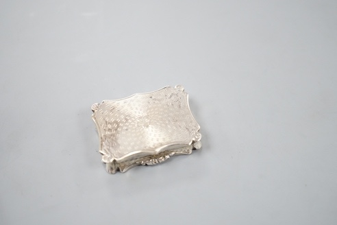 An early Victorian engine turned silver shaped rectangular vinaigrette, by Nathaniel Mills, Birmingham, 1843, 36mm, in leather box.